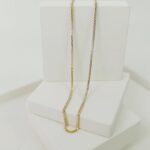 Beautiful Gold Necklace on White Platform